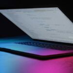 Computadora portátil con código en pantalla en un entorno de trabajo tecnológico