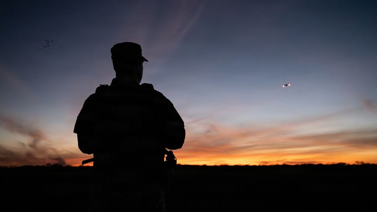 Dron de vigilancia sobre la frontera entre México y Estados Unidos al atardecer